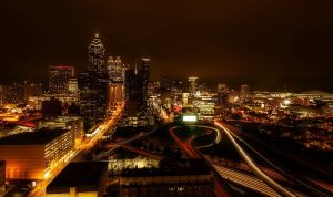 Night view of downtown Atlanta with bright city lights and highways.