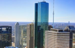 Aerial view of downtown Houston featuring modern high-rise office buildings and the city skyline.