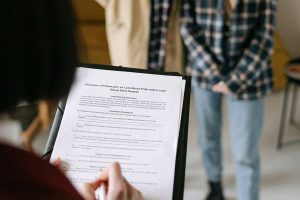 Property manager handing documents to a board member, representing professional HOA management services.